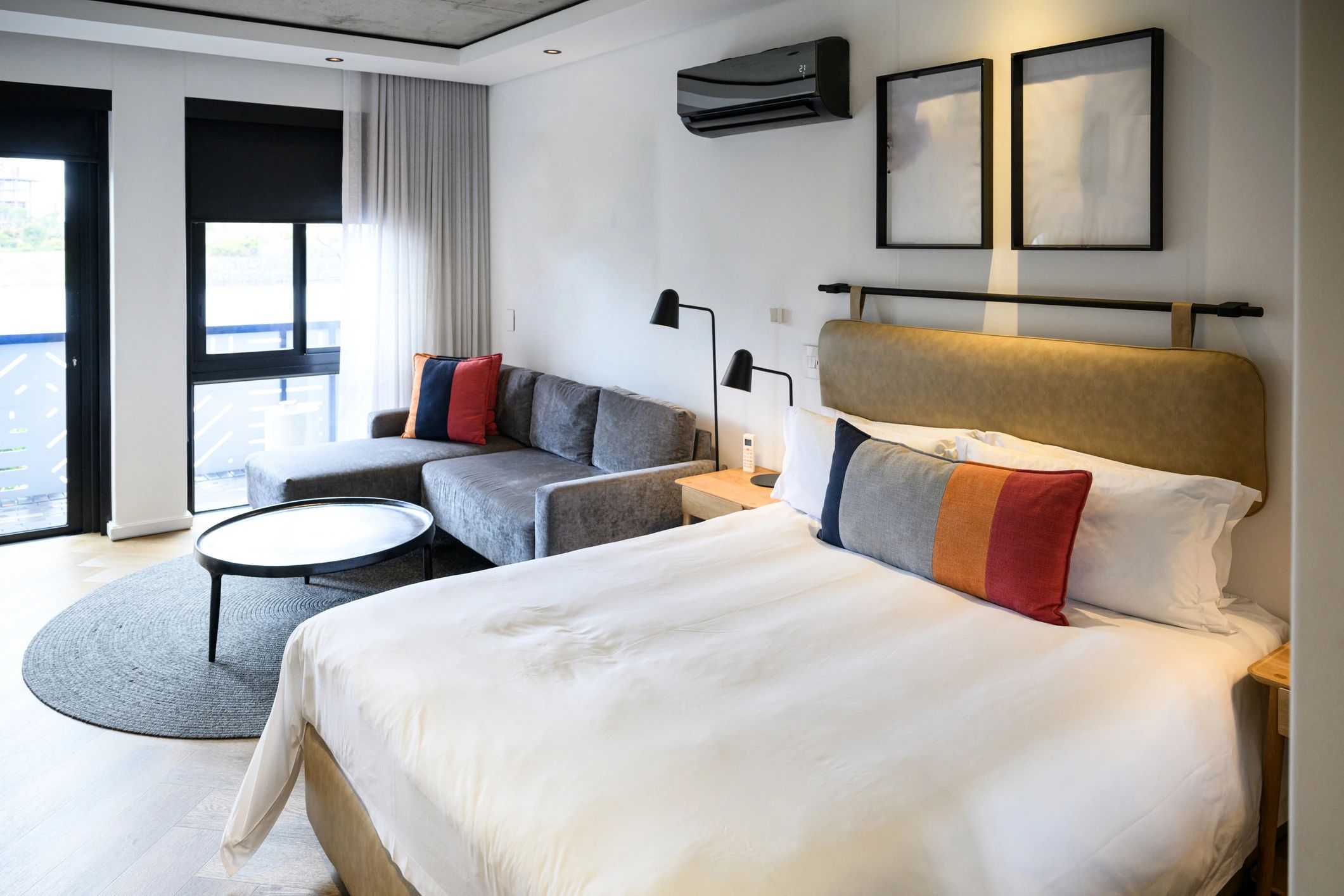 Contemporary hotel room with a king bed and minimalist design